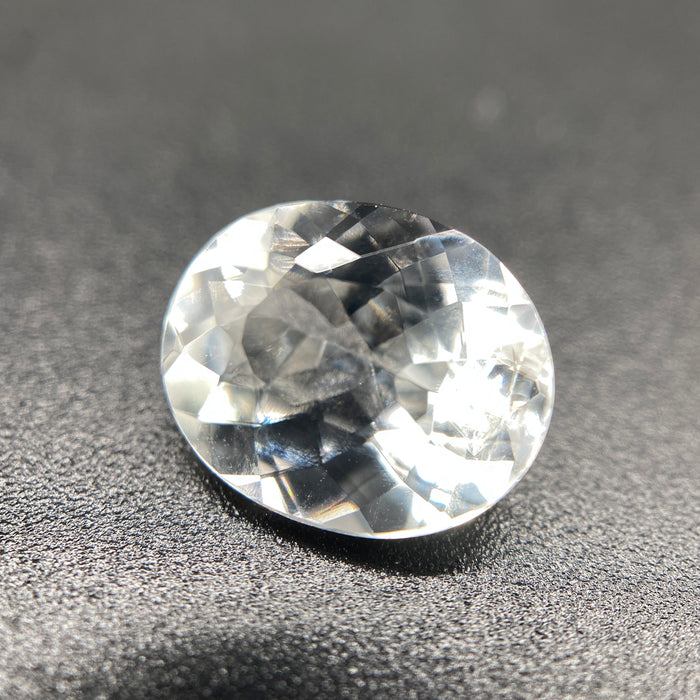 rare brazilian phenakite gemstone faceted oval shape on black background. available at sanctuaryofstones.com
