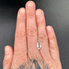 1.80 carat pear cut faceted Brazilian phenakite gemstone on hand to show size. available on sanctuaryofstones.com