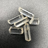 Top view of 6 pieces of Burmese phenakite hexagonal barrel stones on black background. available at sanctuaryofstones.com