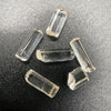 Top view of 6 pieces of Burmese phenakite hexagonal barrel stones on black background. available at sanctuaryofstones.com