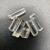 Top view of 6 pieces of Burmese phenakite hexagonal barrel stones on black background. available at sanctuaryofstones.com