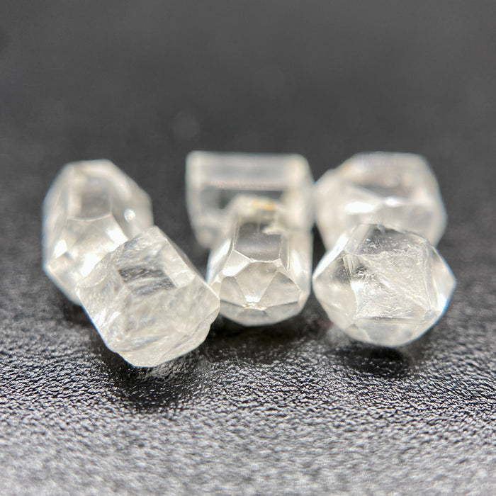 6-piece lot short Burmese phenakite crystals on black background. available at sanctuaryofstones.com