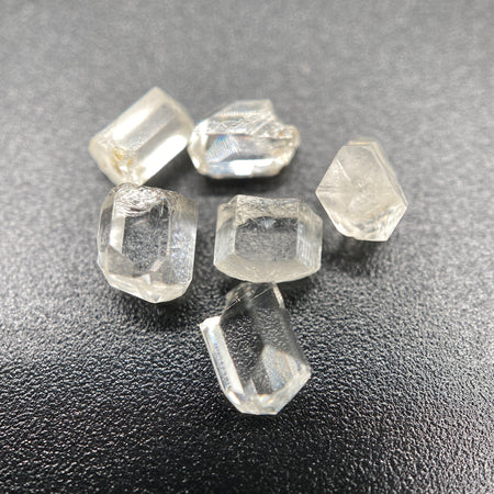 6-piece lot of short, fat, stubby Burmese phenakite crystals on black background. available at sanctuaryofstones.com
