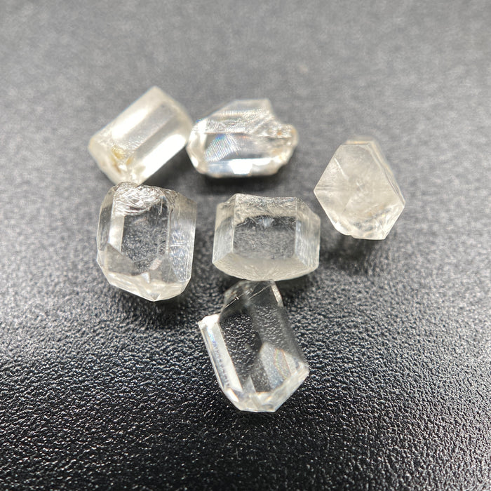 6-piece lot of short, fat, stubby Burmese phenakite crystals on black background. available at sanctuaryofstones.com