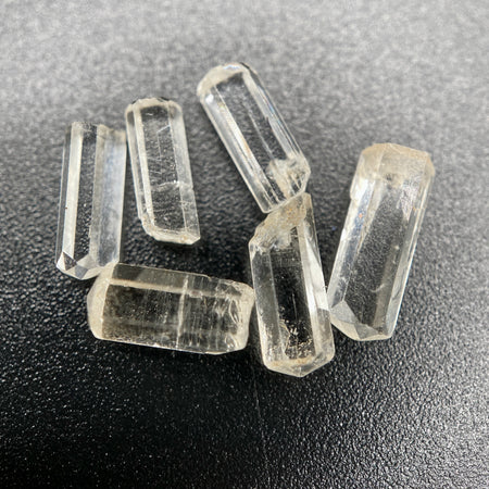0.78 gram 6-piece lot of crystal clear Burmese phenakite crystals on black background available at sanctuaryofstones.com