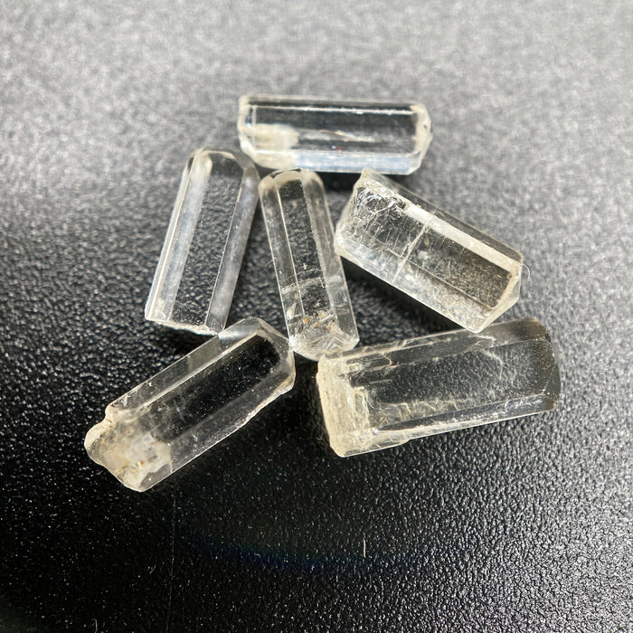 0.78 gram 6-piece lot of crystal clear Burmese phenakite crystals on black background available at sanctuaryofstones.com