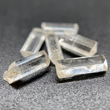 0.78 gram 6-piece lot of crystal clear Burmese phenakite crystals on black background available at sanctuaryofstones.com