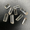 9-piece Burmese phenakite crystal lot on black background. Available at sanctuaryofstones.com