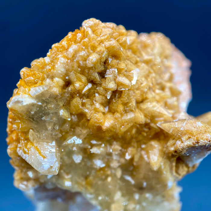 Large Mexican danburite crystal specimen with druzy quartz and golden calcite coating weighing 39.46 grams available on sanctuary of stones dot com photo 7
