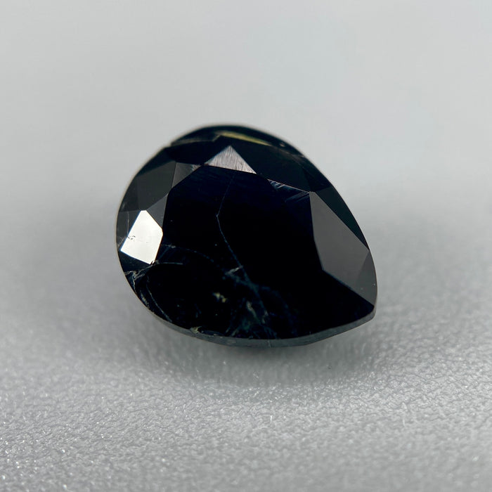 serendibite pear shaped 1.55 carat gemstone, opaque black-blue, very rare gemstone available on sanctuary of stones dot com, sanctuaryofstones.com photo1