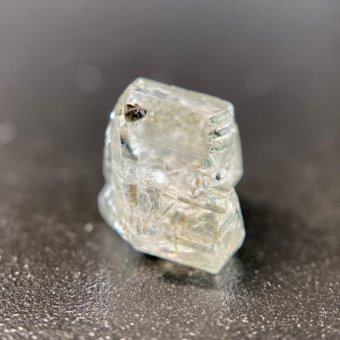 0.81 gram raw Madagascar phenakite crystal with tourmaline inclusions available at sanctuaryofstones.com