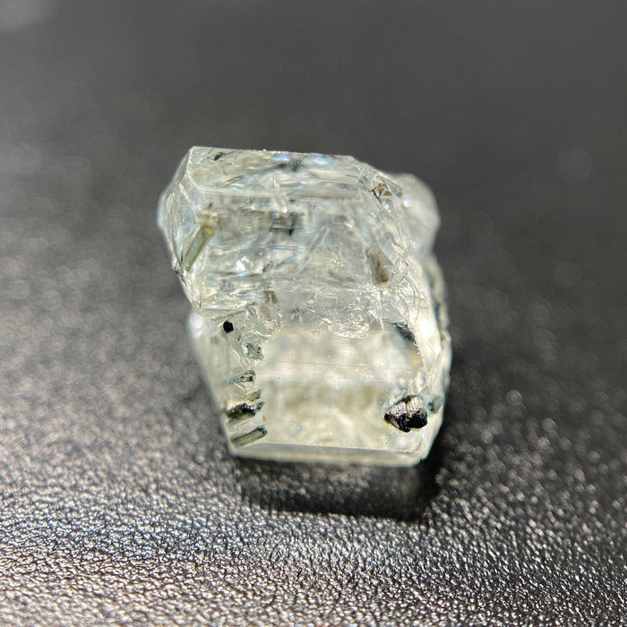 0.81 gram raw Madagascar phenakite crystal with tourmaline inclusions available at sanctuaryofstones.com