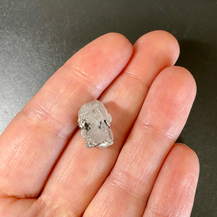 1.95 gram raw Madagascar phenakite crystal with a lot of tourmaline inclusions available at sanctuaryofstones.com