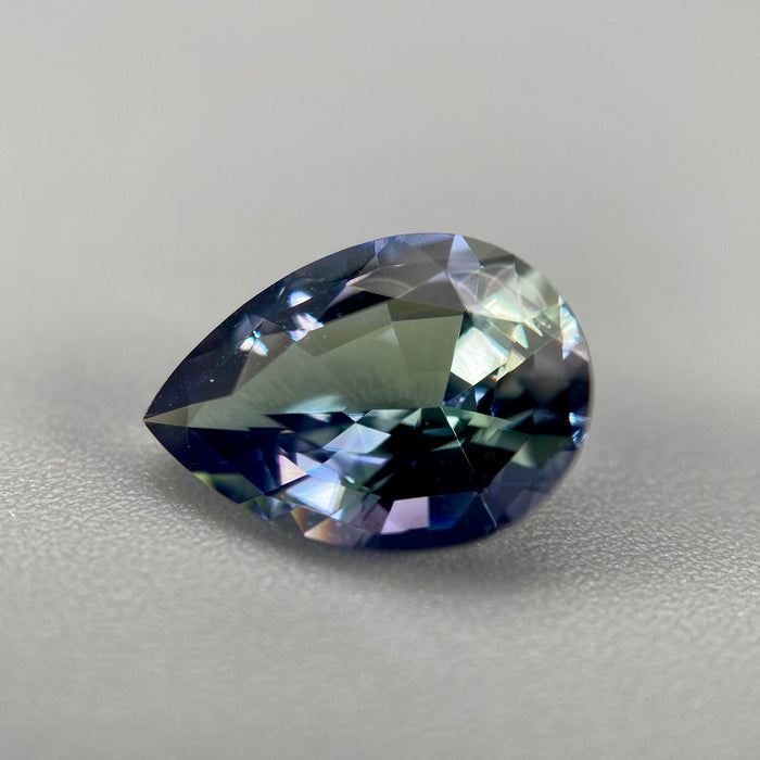 untreated peacock tanzanite pear cut gemstone, 1.88 carats, trichroic color phenomenon with blue, violet, fern-green colors, from sanctuary of stones dot com, image 2