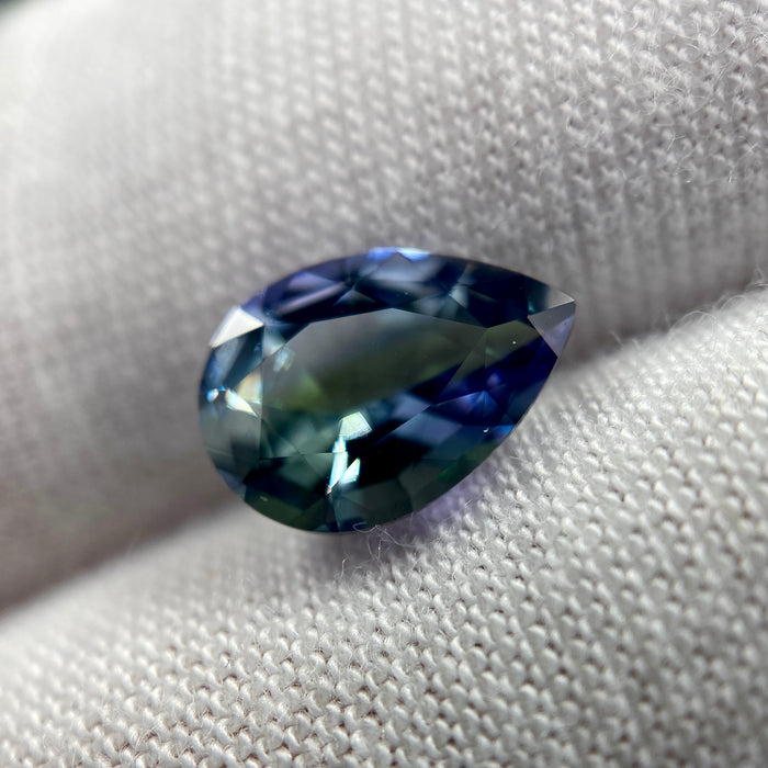 untreated peacock tanzanite pear cut gemstone, 1.88 carats, trichroic color phenomenon with blue, violet, fern-green colors, from sanctuary of stones dot com, image 9