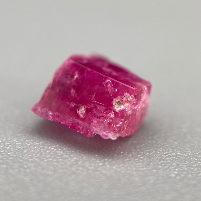 Extremely rare red beryl crystal 0.59 carats, broken crystal shape, raspberry red color great translucency, available at sanctuaryofstones.com