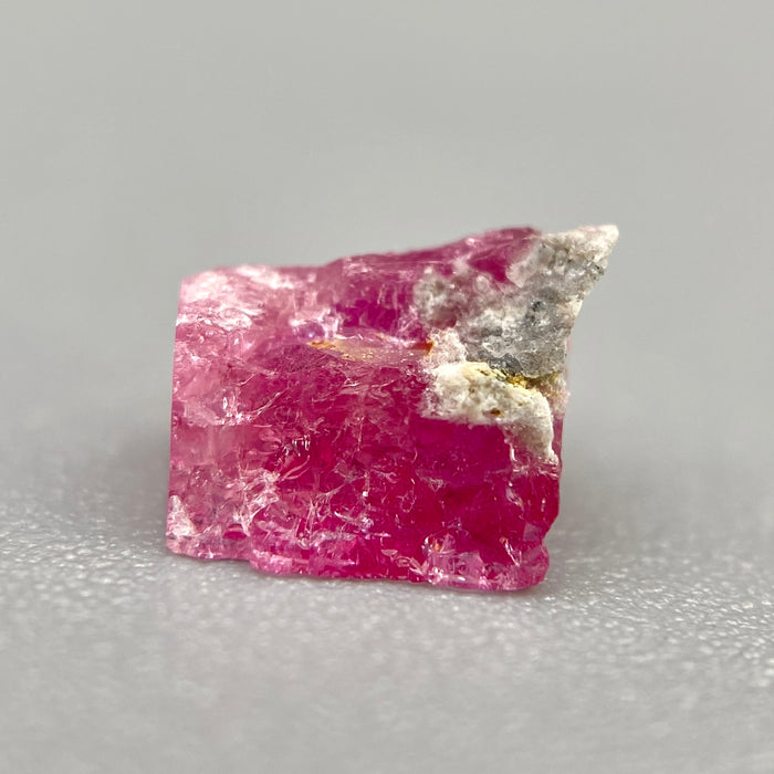 Extremely rare red beryl crystal 0.59 carats, broken crystal shape, raspberry red color great translucency, available at sanctuaryofstones.com
