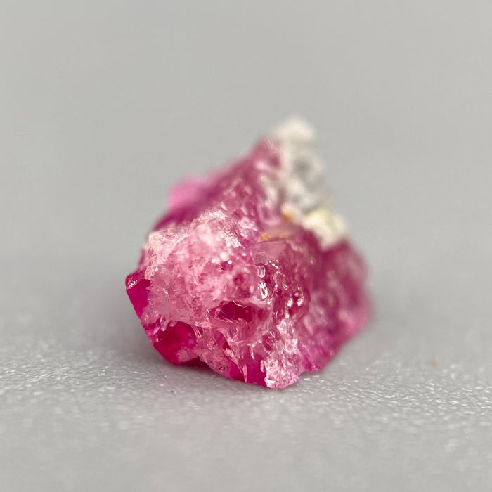 Extremely rare red beryl crystal 0.59 carats, broken crystal shape, raspberry red color great translucency, available at sanctuaryofstones.com