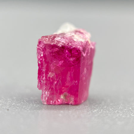 Extremely rare red beryl crystal 0.59 carats, broken crystal shape, raspberry red color great translucency, available at sanctuaryofstones.com
