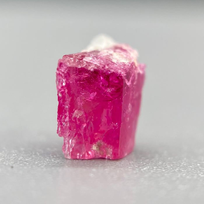 Extremely rare red beryl crystal 0.59 carats, broken crystal shape, raspberry red color great translucency, available at sanctuaryofstones.com
