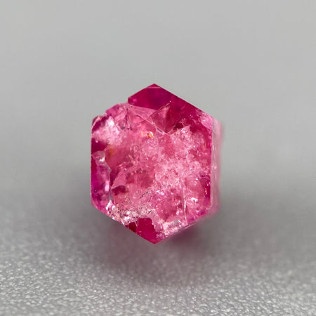 Extremely rare red beryl crystal 0.71 carats, hexagonal shape, raspberry red color great translucency, available at sanctuaryofstones.com
