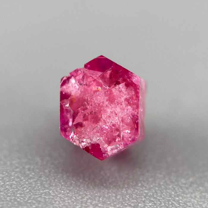 Extremely rare red beryl crystal 0.71 carats, hexagonal shape, raspberry red color great translucency, available at sanctuaryofstones.com