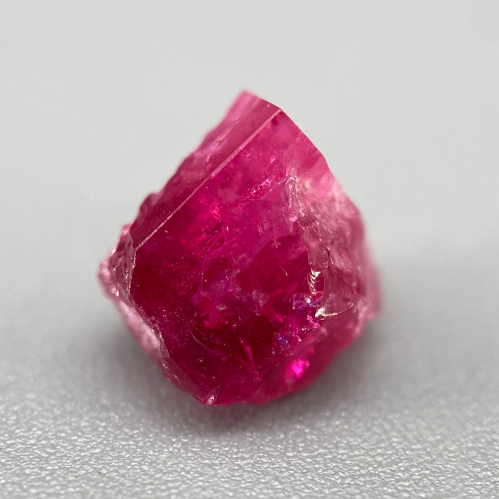 Extremely rare red beryl crystal 1.55 carats, broken but with two natural crystal faces, richest top-tier raspberry red color great translucency, available at sanctuaryofstones.com