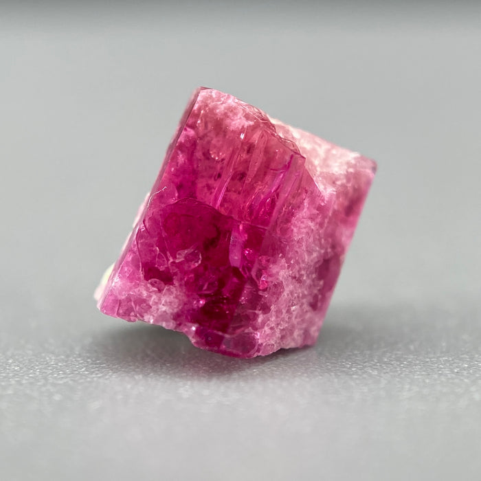 Extremely rare red beryl crystal on matrix, 1.67 carats, two natural crystal faces, raspberry red color great translucency, available at sanctuaryofstones.com