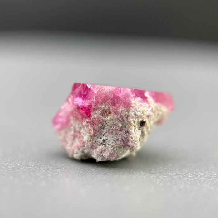 Extremely rare red beryl crystal on matrix, 1.67 carats, two natural crystal faces, raspberry red color great translucency, available at sanctuaryofstones.com