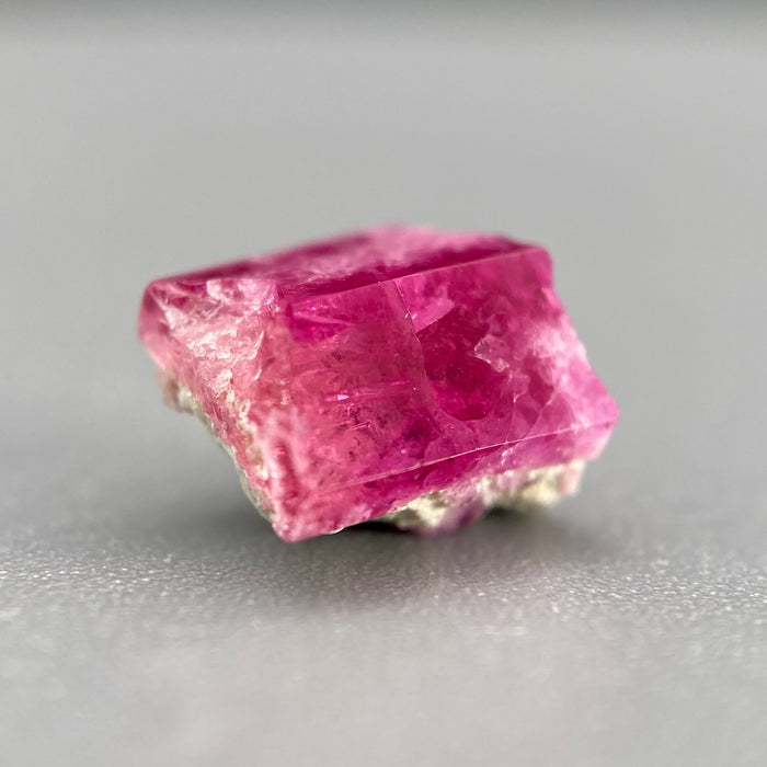 Extremely rare red beryl crystal on matrix, 1.67 carats, two natural crystal faces, raspberry red color great translucency, available at sanctuaryofstones.com