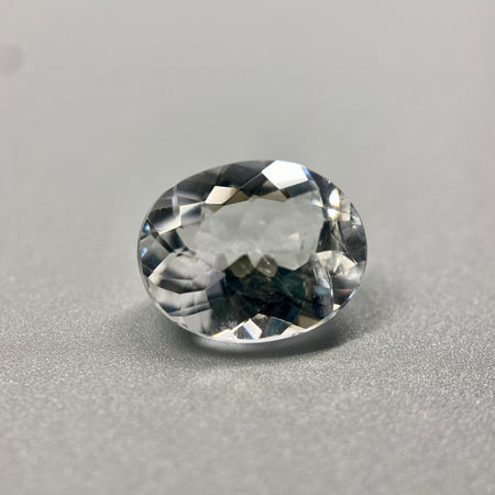 rare brazilian phenakite gemstone faceted oval shape on black background. available at sanctuaryofstones.com