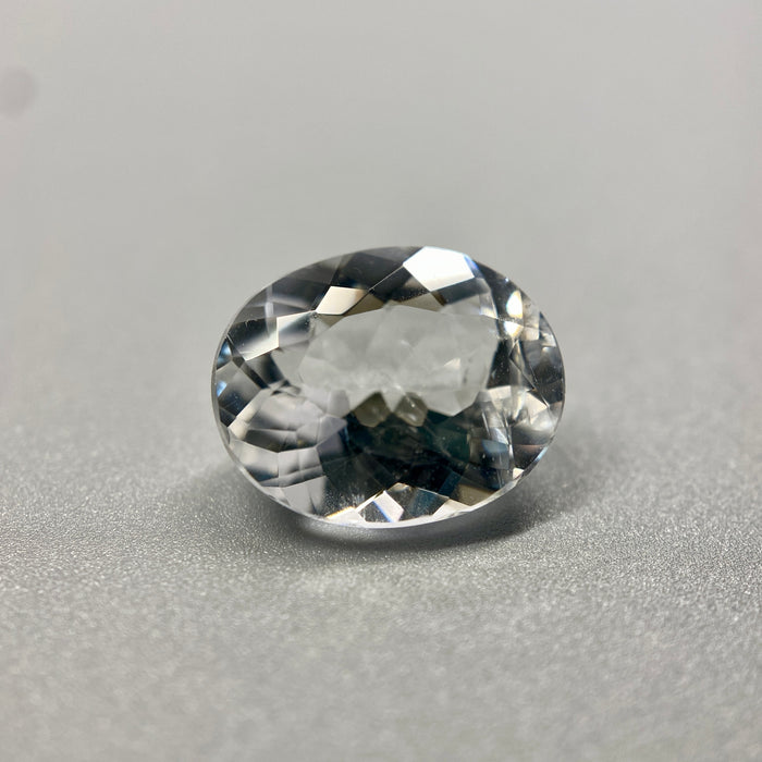 rare brazilian phenakite gemstone faceted oval shape on black background. available at sanctuaryofstones.com