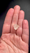 rare Nigerian Okuta-Didan phenakite crystal on a hand to show size. available at sanctuaryofstones.com