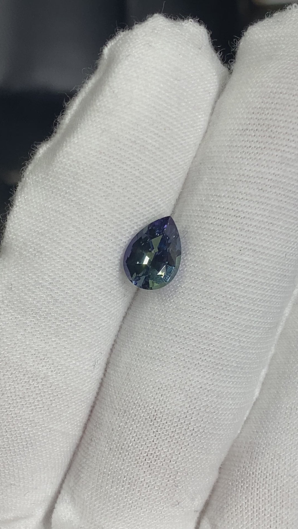 untreated tanzanite pear cut gemstone, 1.88 carats, trichroic color phenomenon with blue, violet, fern-green colors, from sanctuary of stones dot com, video 1