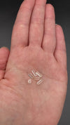 Top view of 6 pieces of Burmese phenakite hexagonal barrel stones on hand to show size. available at sanctuaryofstones.com