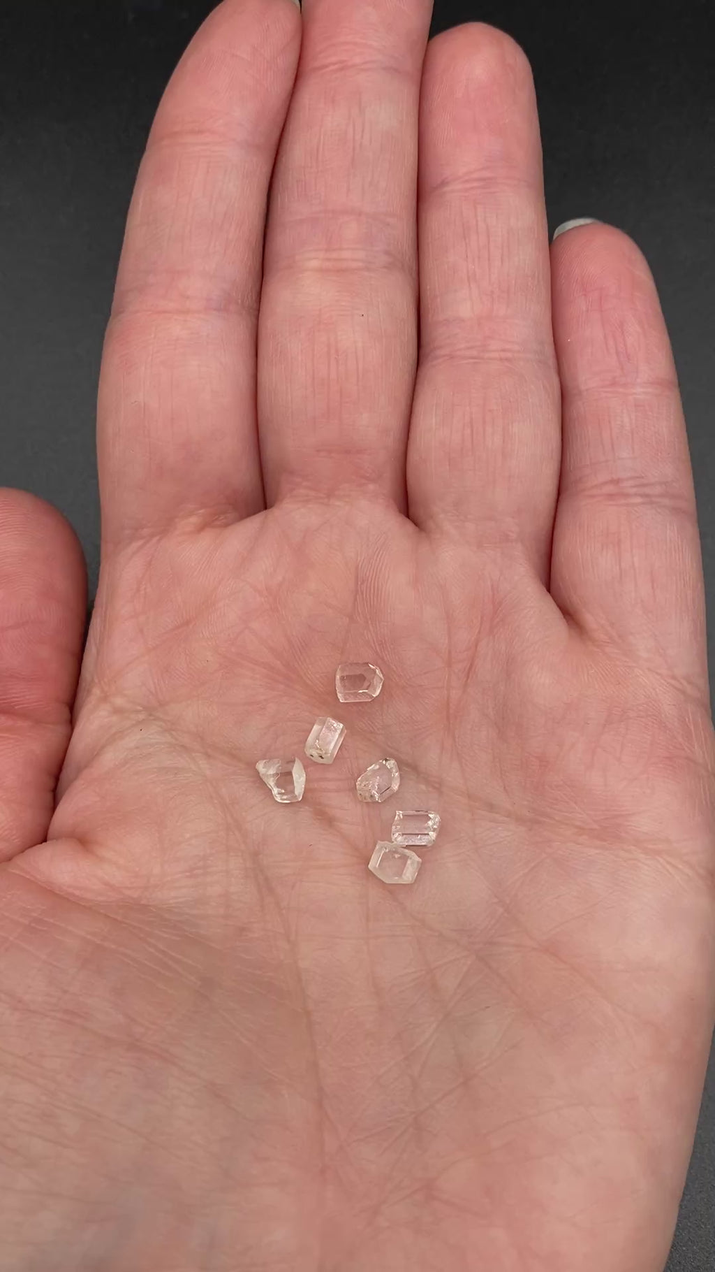 6-piece lot of short, fat, stubby Burmese phenakite crystals on hand to show size. available at sanctuaryofstones.com