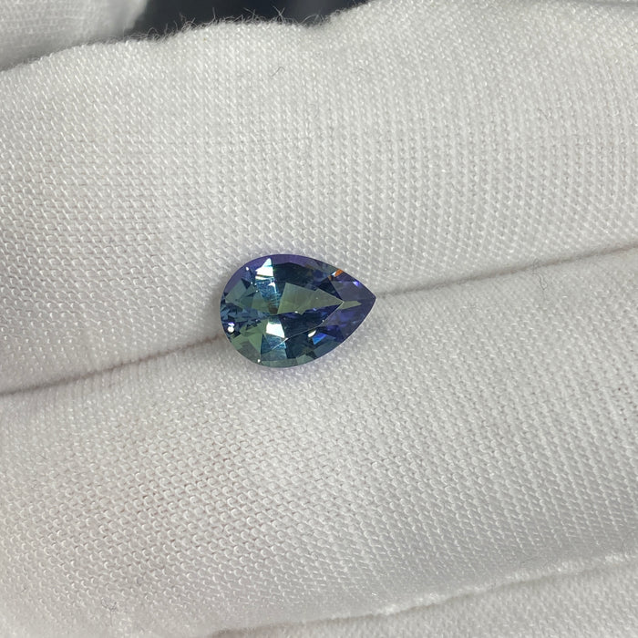 untreated tanzanite pear cut gemstone, 1.88 carats, trichroic color phenomenon with blue, violet, fern-green colors, from sanctuary of stones dot com, image 2