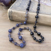 photo 4 of sanctuary vibrational jewelry's Harmonics of Light and Shadow hand-knotted beaded necklace with natural iolite rutilated gray moonstone and indigo gabbro