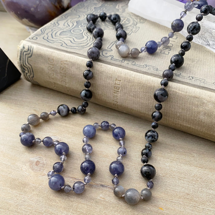 photo 3 of sanctuary vibrational jewelry's Harmonics of Light and Shadow hand-knotted beaded necklace with natural iolite rutilated gray moonstone and indigo gabbro