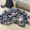 photo 2 of sanctuary vibrational jewelry's Harmonics of Light and Shadow hand-knotted beaded necklace with natural iolite rutilated gray moonstone and indigo gabbro