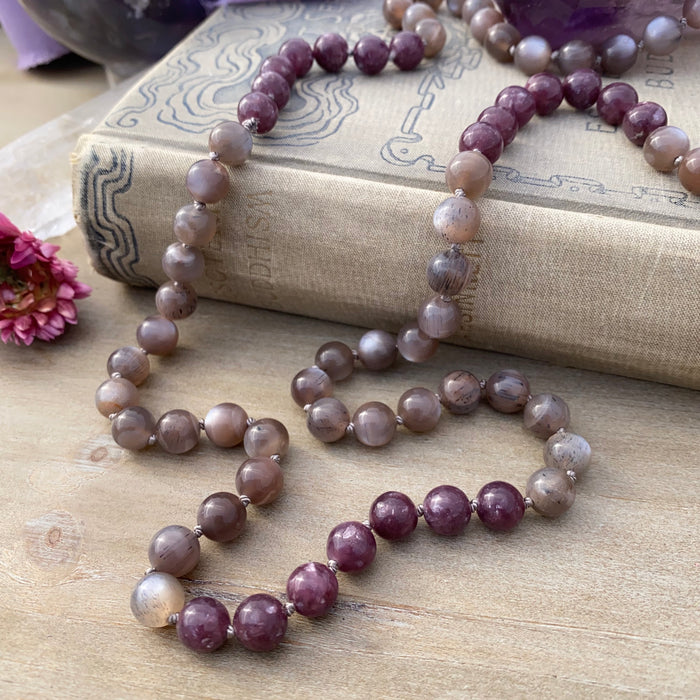 photo 1 of sanctuary vibrational jewelry's Calm Beyond the Veil hand-knotted beaded necklace with natural rutilated taupe moonstone and raspberry lepidolite with mica flecks