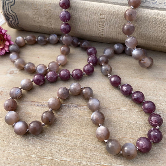 photo 2 of sanctuary vibrational jewelry's Calm Beyond the Veil hand-knotted beaded necklace with natural rutilated taupe moonstone and raspberry lepidolite with mica flecks