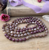 photo 3 of sanctuary vibrational jewelry's Calm Beyond the Veil hand-knotted beaded necklace with natural rutilated taupe moonstone and raspberry lepidolite with mica flecks